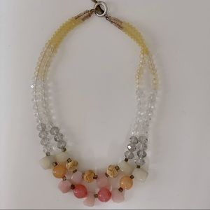 Short necklace with coral colored beads